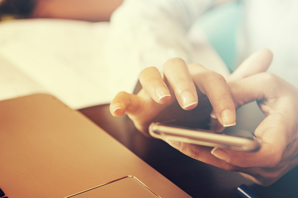 a girl touching a smartphone